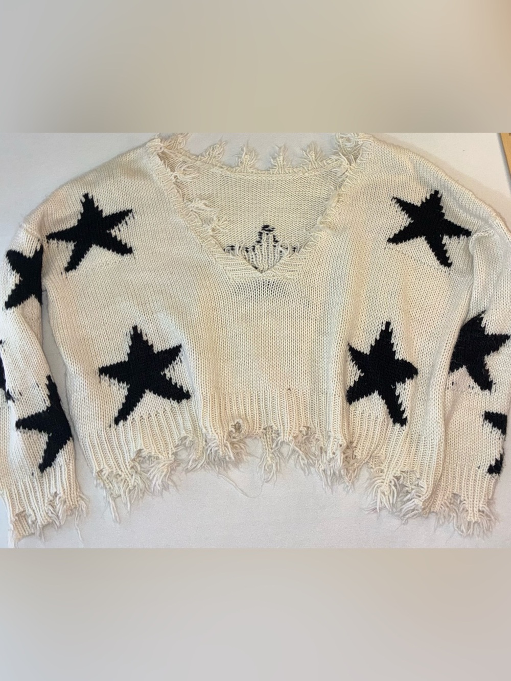 Storia Ivory Distressed V-Neck Sweater with Black Star Motif